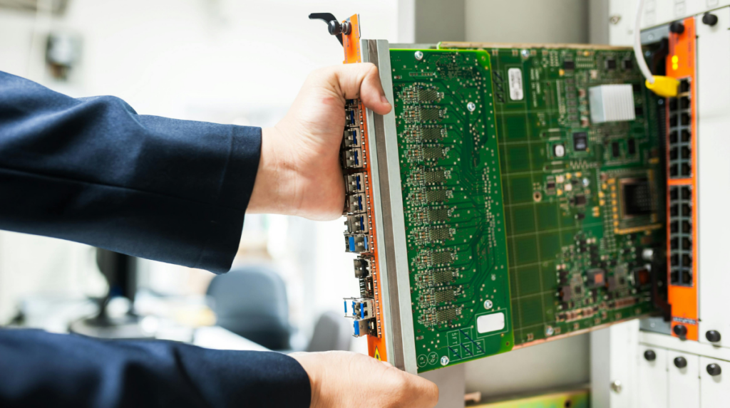 Data center technician installing circuit board into server hardware in a data center environment