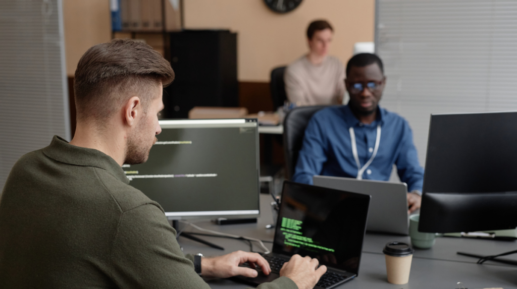 IT security professionals monitoring code and systems in a cybersecurity operations environment